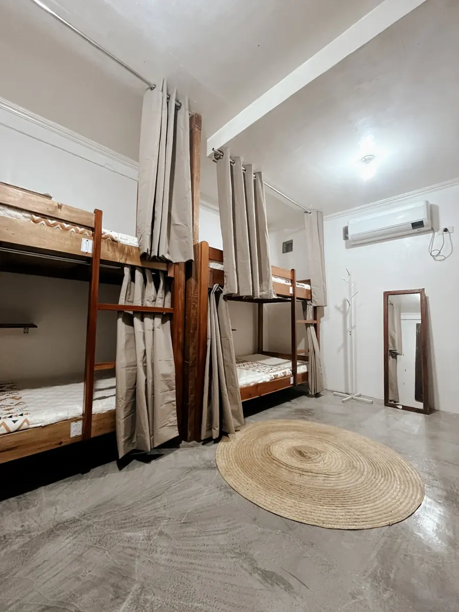 Mixed dorm with wooden bunk beds and air conditioning